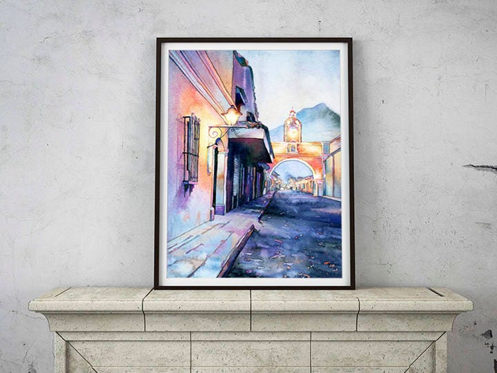 Watercolor painting of the Arch of Santa Catalina framed by colonial facades and distant volcanoes—great for cultural home decor or as a meaningful art gift.