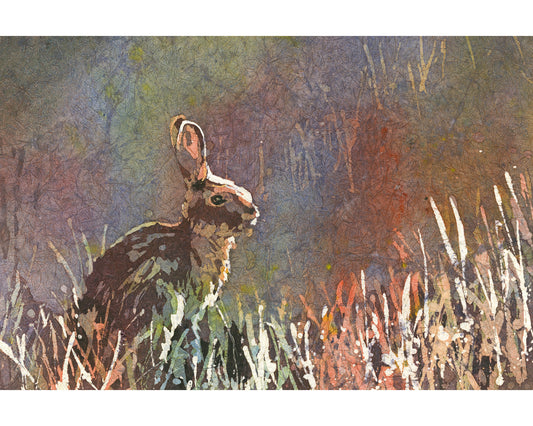 Colorful batik watercolor painting of a bunny rabbit nestled in tall green grass, ideal handmade kids room decor or unframed art for animal-themed nursery walls