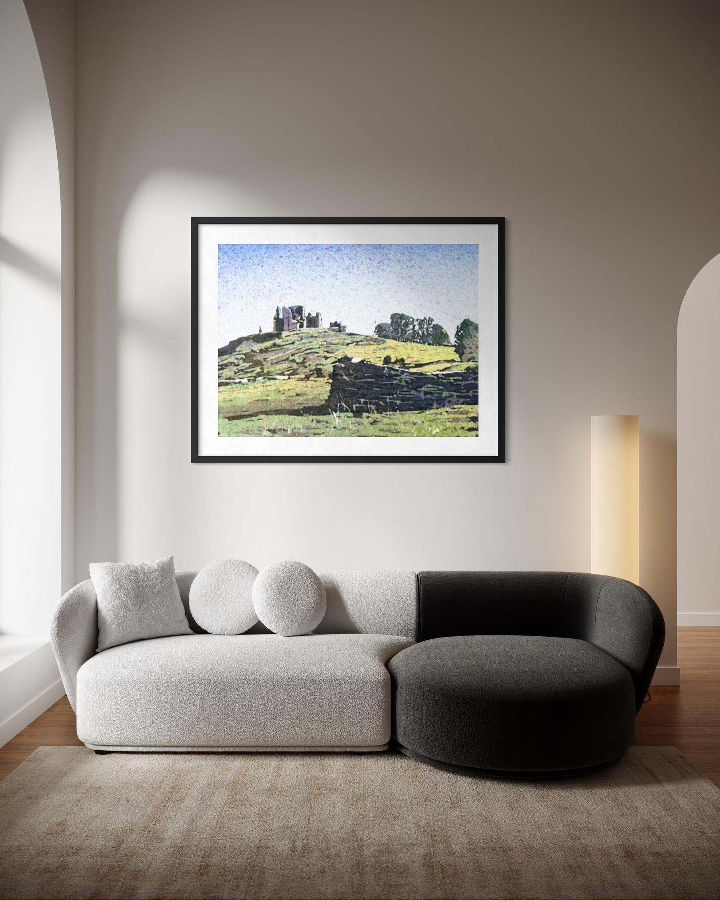 Framed original watercolor painting of the Rock of Cashel in Ireland showing castle ruins on a green hillside above a stone wall in a modern living room
